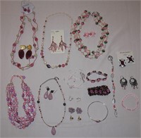 Assorted pink necklaces, earrings, bracelets