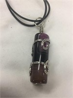 Amethyst pendant wrapped in silver wire with cord