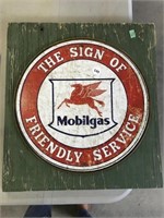 Round Metal Mobilgas Sign Mounted On Wood