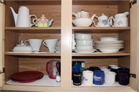 two cupboards with tea pots and dishes