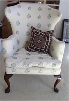 Floral upholstered arm chair with wooden legs