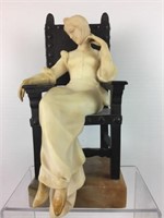 Alabaster lady sitting in bronze chair on marble