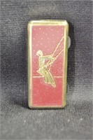 BRASS AND ENAMEL PILL BOX WITH SWINGING LADY 1" X