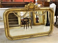 Gilt Shell and Floral Swag Crowned Beveled Mirror.