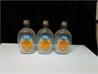 Grouping of 3 collectable log cabin syrup bottles
