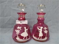 PAir of Mary Gregory dresser bottles on cranberry