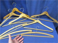 8 old wooden hangers (some w/ advertising)