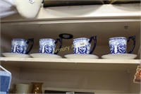 BLUE AND WHITE DECORATED CUPS AND SAUCERS