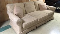 Beige couch with 2 throw pillows. 70” x 37“ x 31“.