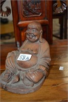 Old carved wooden seated happy Buddha,