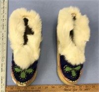 Pair of ugruk hide slippers with dyed seal decorat