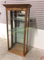 Lighted oak display case with glass shelves.