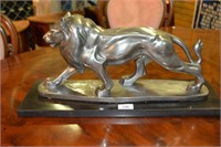 Statue of a prowling lion, silver gilt finish,