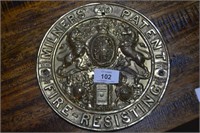 Antique pressed brass fire plaque