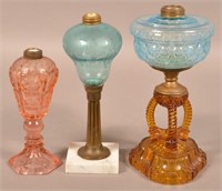 Three Antique Colorled Glass Fluid Lamps.