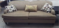 Green sofa with accent pillows