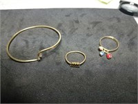 2 gold rings and a gold bracelet marked 14K they