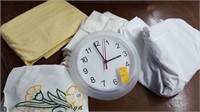 Basket of twin sheets and clock