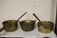 Two brass pans and a jam pan.