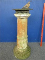 antique iron sundial on concrete pedestal