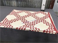 Red and white half square triangle quilt