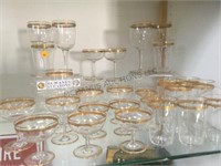LARGE COLLECTION OF WINE GLASSES WITH ORNATE TRIM