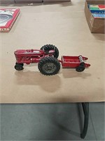 Metal toy tractor with manure spreader.