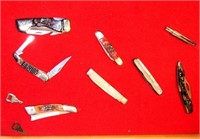 Showcase full of (8) folding pocket knives