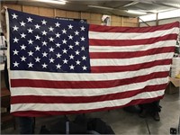 Full size American flag. Measures over 100 inches