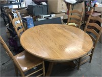 Round table with four chairs. Top has bolts to