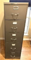 Tall metal filing cabinet with five drawers.