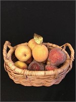 Small wicker basket containing faux fruit