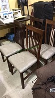 4 matching slat back chairs with plastic over the