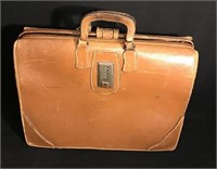Vintage well used briefcase with padlock latch.