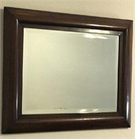 Brown wooden rectangle shape wall mirror.