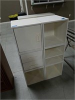 White cabinet with drawers and shelf.