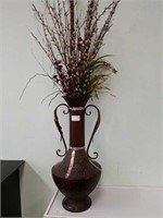 Large metal vase with flowers