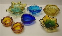 Seven coloured glass ashtrays