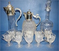 Two assorted silver plated & glass claret jugs