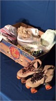 Box of linens and pair of roller skates