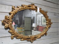 Ornate gold oval mirror