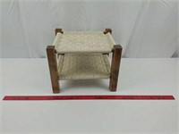 Small footstool with woven surface