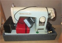 Vintage Brother sewing machine with attachments.