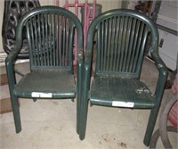 (2) Green plastic outdoor chairs.