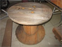 Large wood spool. Measures 25" tall.