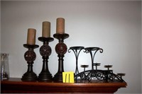 four metal candle holders and three