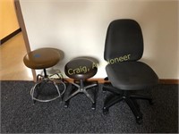 Pair of stools on casters and office chair on cast