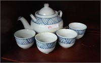 Oriental teapot and 4 cups (small chip on one)