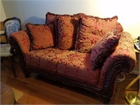 Red loveseat and pillows