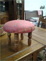 Small round footstool in red cover